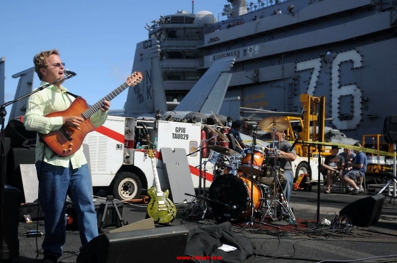 US_Navy_091016-N-9132C-416_Sailors_and_Tiger_Cruise_participants_listen_to_a_jazz_concert_with_Steve_Oliver_on_the_flight_deck_aboard_the_aircraft_carrier_USS_Ronald_Reagan_%28CVN_76%29.jpg